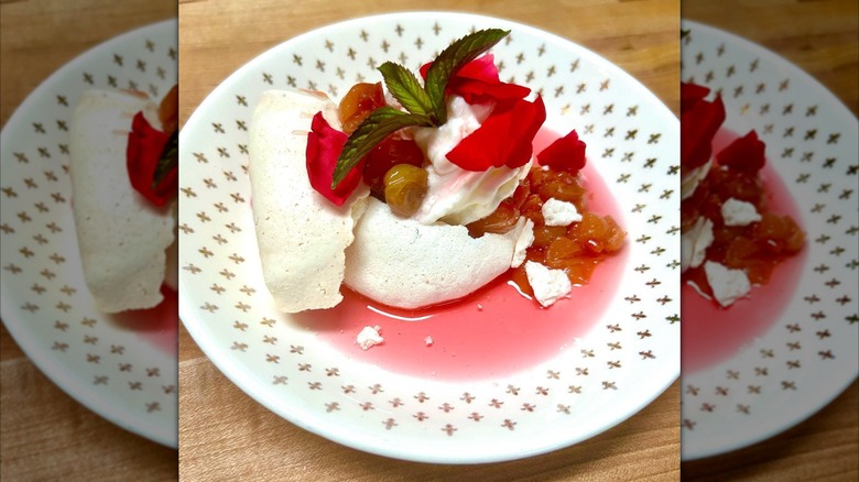 Cherry pavlova decorated with rose petals