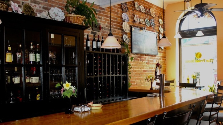 Bar area with bottles on display and brick wall