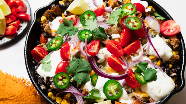 Southwest sweet potato skillet with toppings besides it