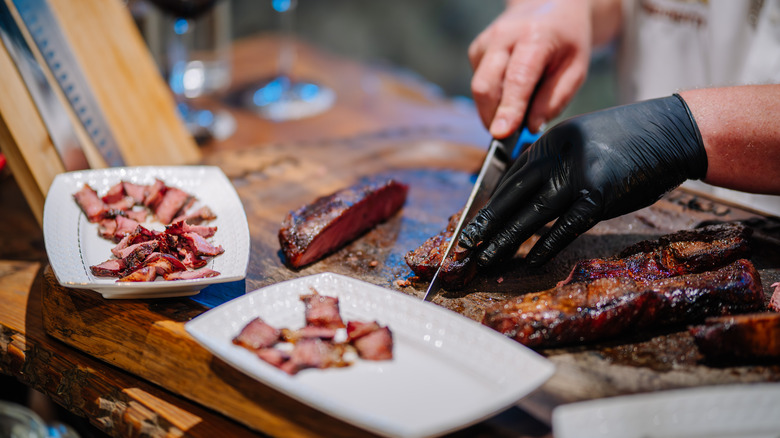Steak being sliced by chef