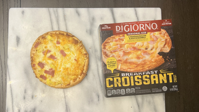 DiGiorno's breakfast croissant ham and egg pizza on a marble slab