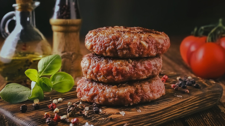 stack of burger patties with seasoning
