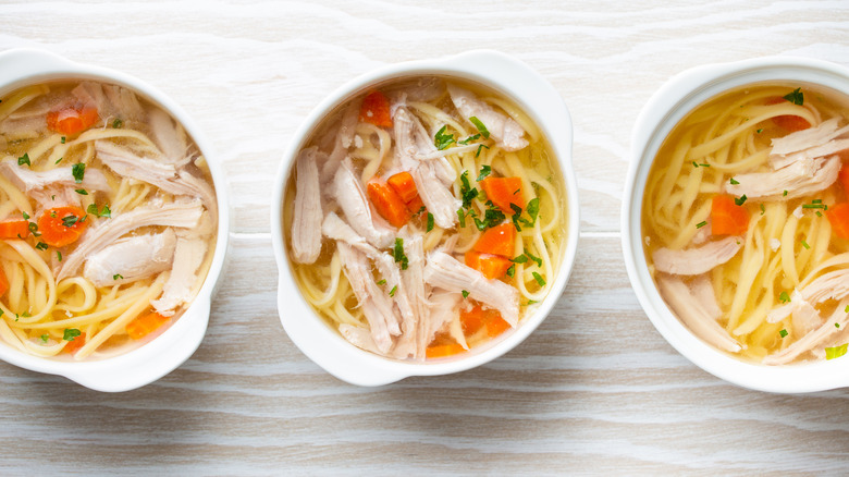 Three bowls of chicken noodle soup