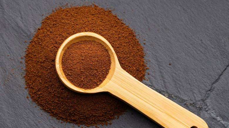 instant cold brew in a wooden spoon and pooled around it