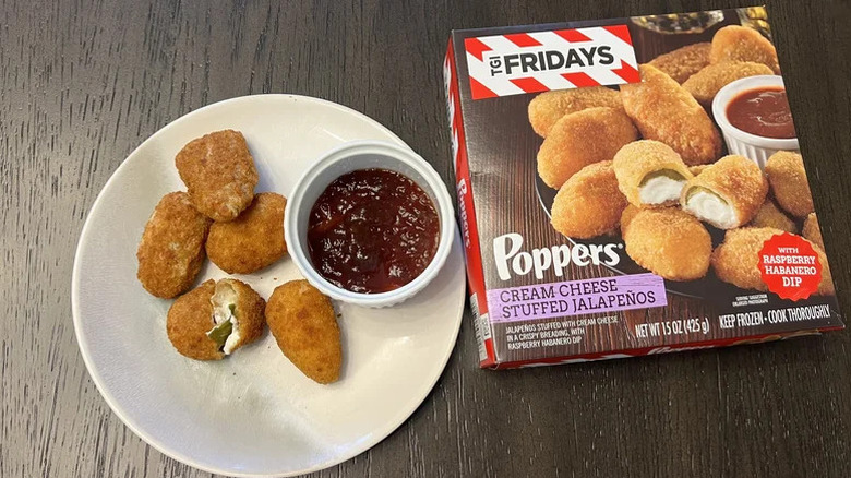 Plate of TGI Fridays Cream Cheese Stuffed Jalapeño Poppers with dipping sauce, next to box