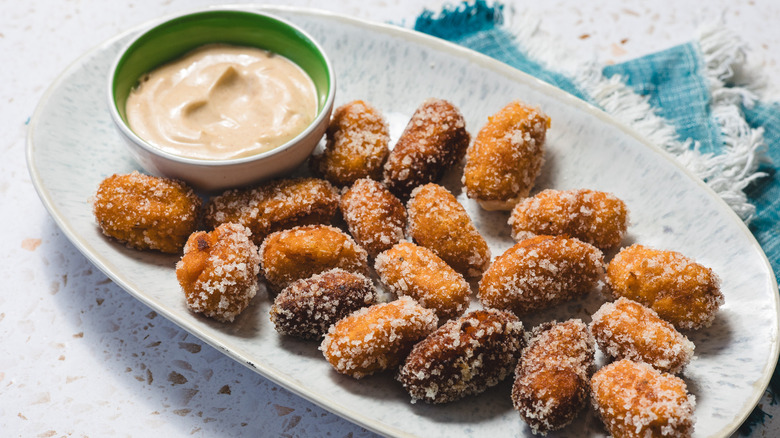 sweet potato tater tots on a blue oval plate