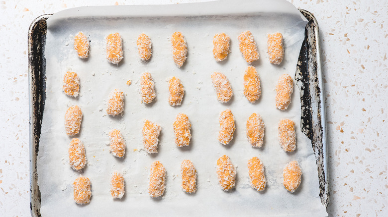 Raw sweet potato tater tots on cookie sheet