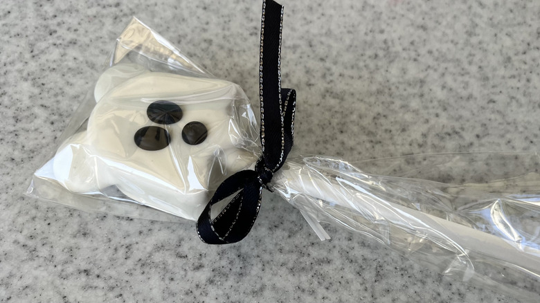 Ghost Mickey Cake Pop wrapped up in plastic and tied with a black bow