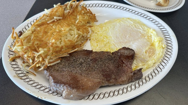 Delmonico steak and eggs on white plate at Waffle House