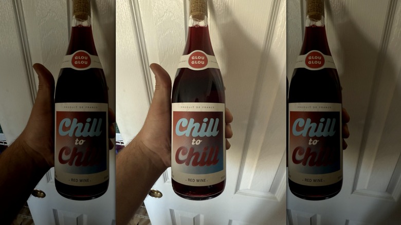Hand holding bottle of Chill to Chill Red Wine