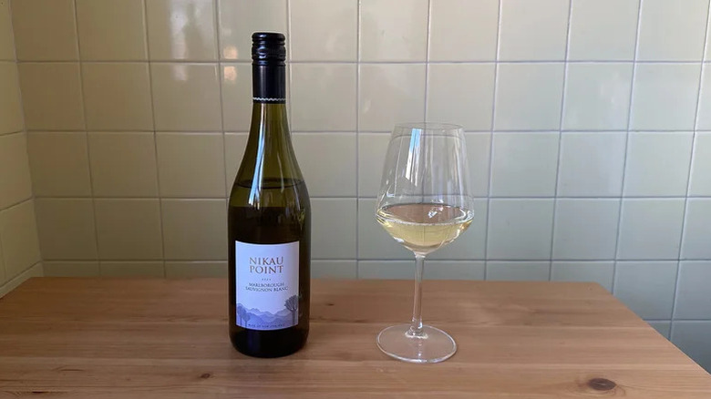 Nikau Point Marlborough Sauvignon Blanc in glass on wooden table