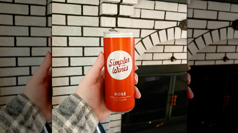 Hand holding can of Simpler Wines rosé