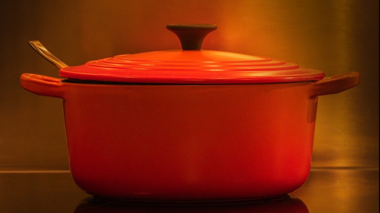 an Orange enamel pot with lid