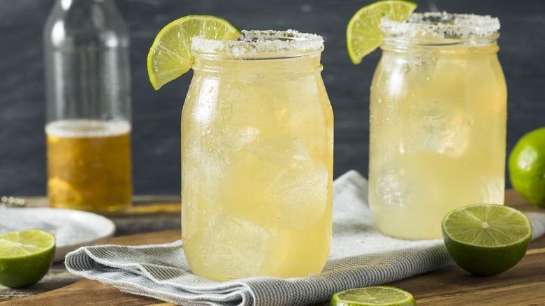 Two beer margaritas with salted rim and slice lime