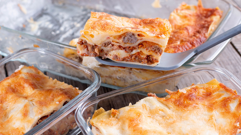 Person taking lasagna out of a container