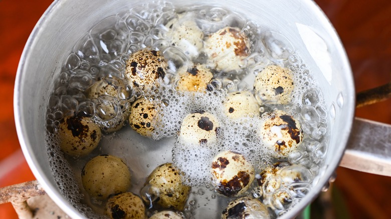 Quail eggs boiling in a pot