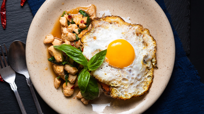 Fried egg with chicken, basil