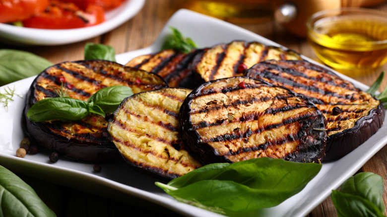 Grilled eggplant slices on a plate.
