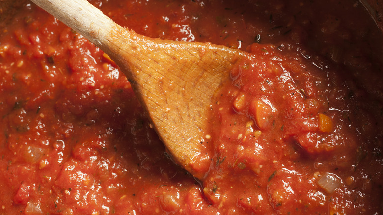 Tomato sauce with wooden spoon 