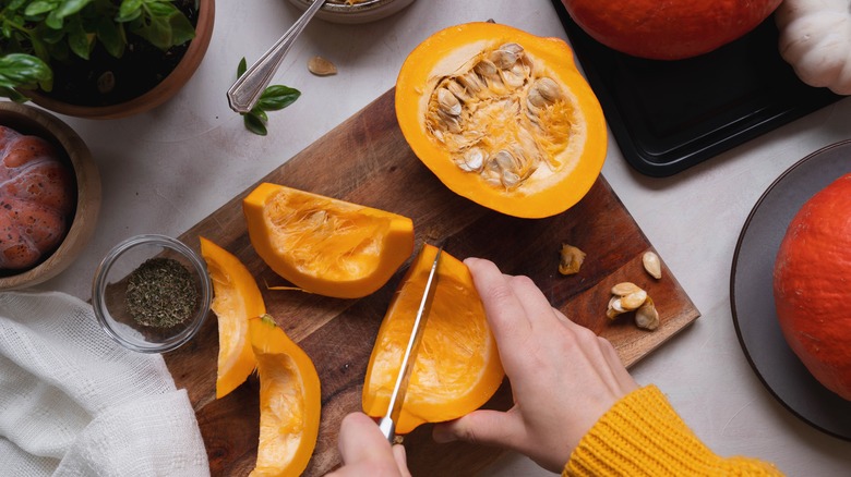 slicing pumpkin on cutting board