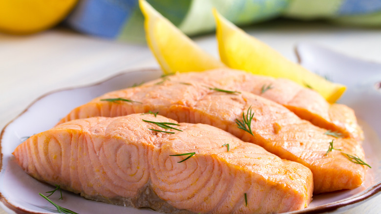 poached salmon on a plate with lemon