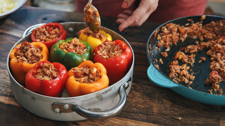 Peppers in a pan being stuffed 