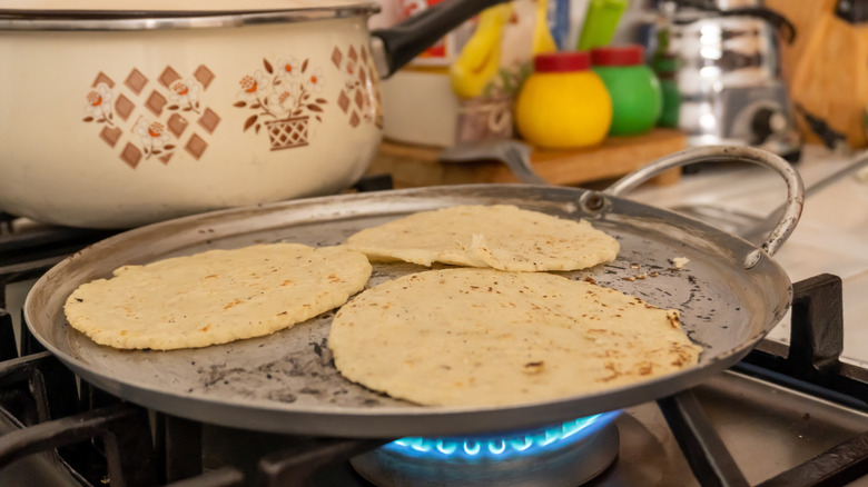 Reheating corn tortillas on a traditional comal