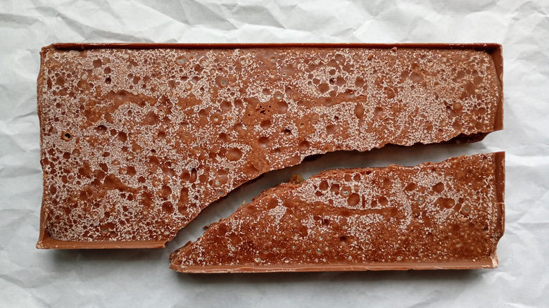 A bar of cracked chocolate with sugar bloom