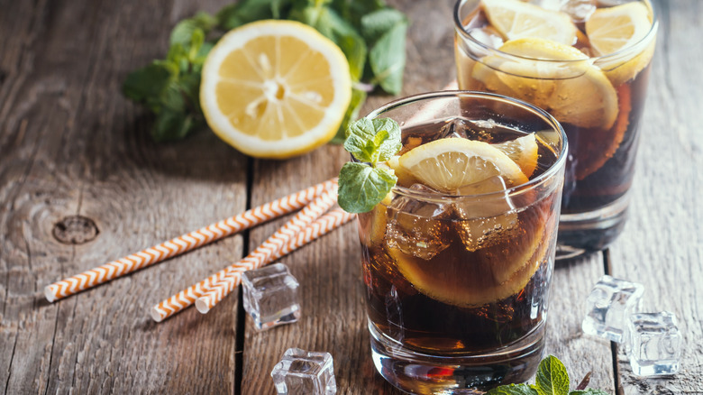 Cuba Libre cocktails made with lemon, mint, and dark rum