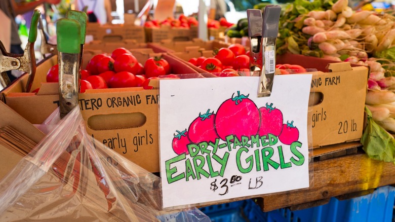 Boxes of dry-farmed 'Early Girl' tomatoes at a farmer's market