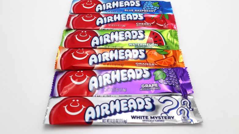 Series of differently flavored wrapped Airheads on white background