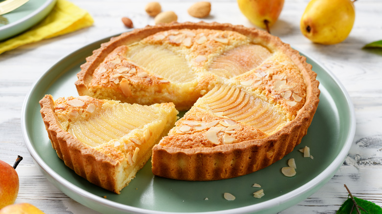 Closeup of a pear almond frangipane tart on a plate