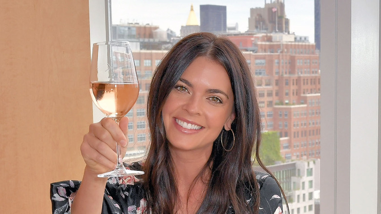 Katie Lee Biegel holding glass of wine 