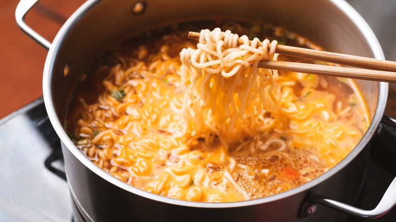 boiling ramen noodles and broth in pot