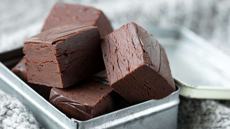 Close-up of cubical pieces of fudge in a tin