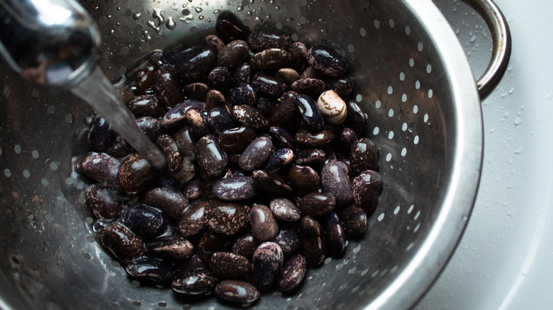 Rinsing black beans in colander