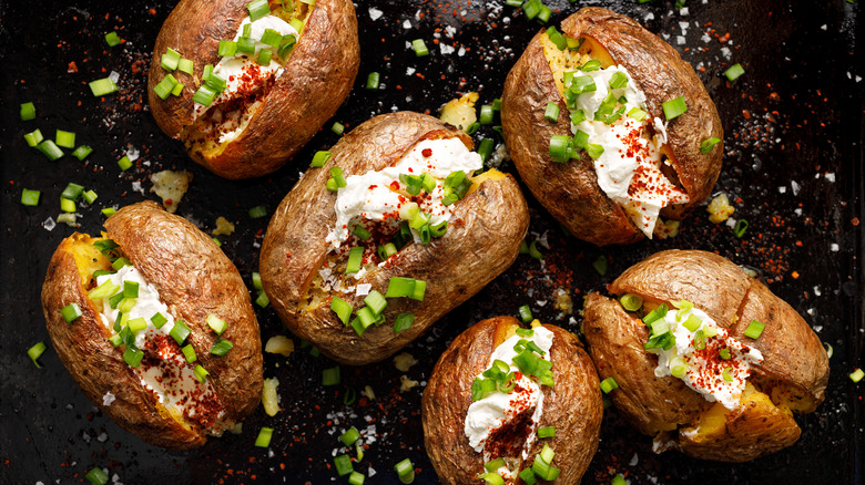 baked potatoes covered in toppings