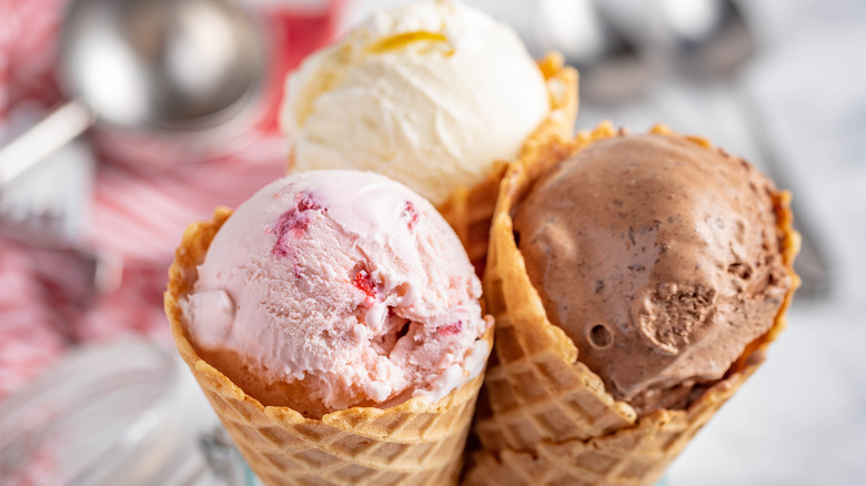 Three scoops of ice cream in cones.