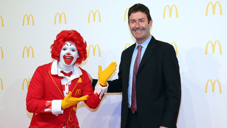 Steve Easterbrook and Ronald McDonald at a restaurant