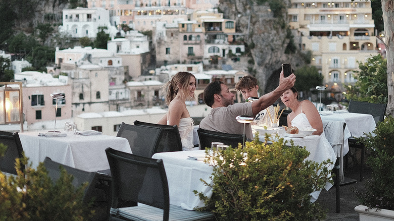 A group of friends at a cliffside dinner with no one else around