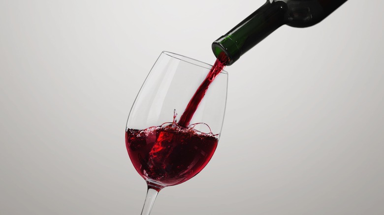 Pouring red wine into a glass