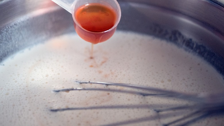 rum being poured into a batter