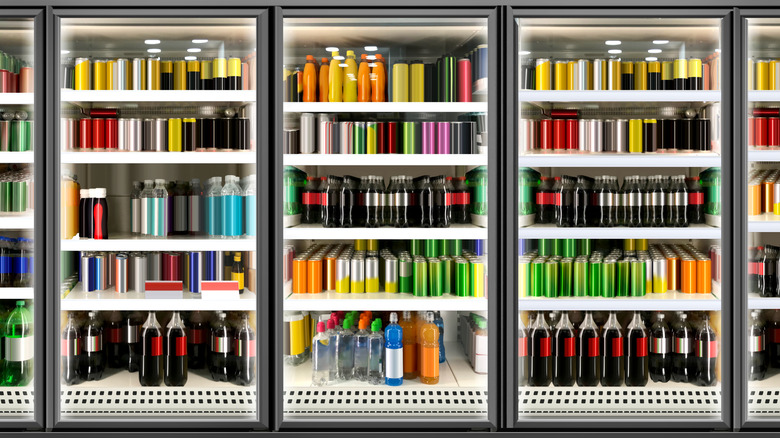 Supermarket coolers with various bottled and canned drinks inside