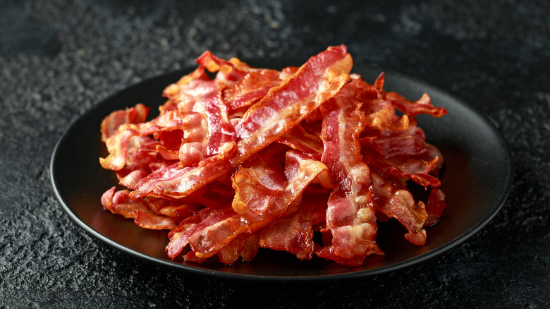crispy bacon on black plate