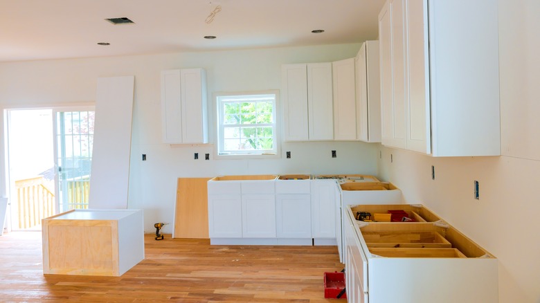 Kitchen cabinets being installed during a kitchen renovation