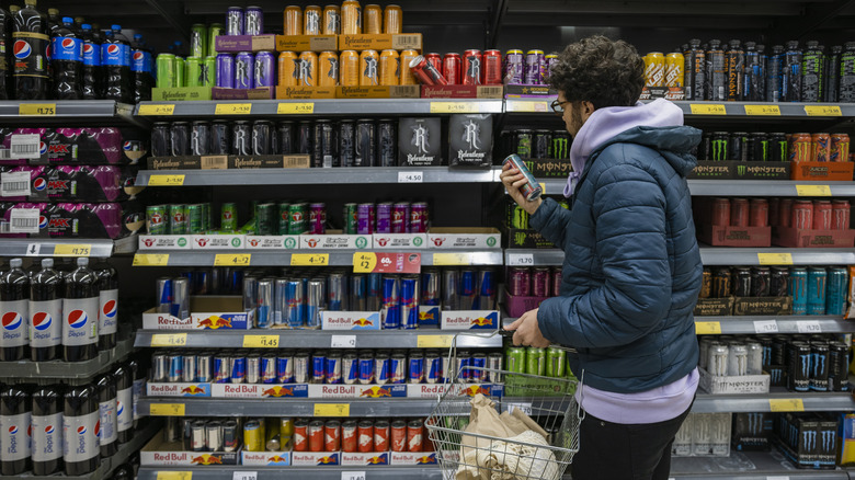 Person shopping energy drinks grocery store