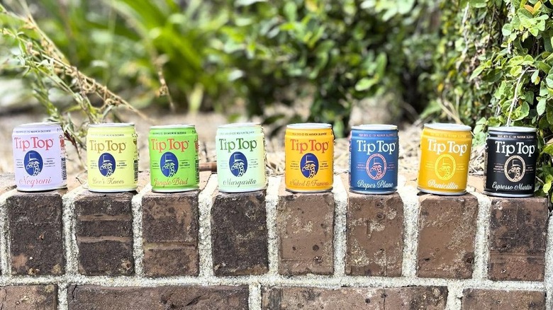 Tip Top canned cocktails on brick shelf