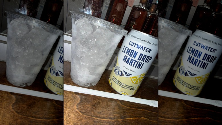 Can of Cutwater lemon drop martini next to plastic cup with ice