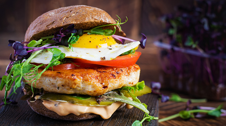 Turkey burger with egg, tomato, and greens