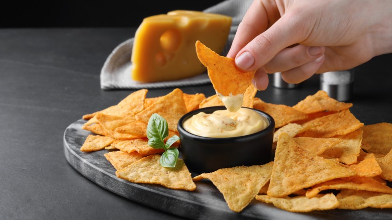 dipping chips in cheese sauce